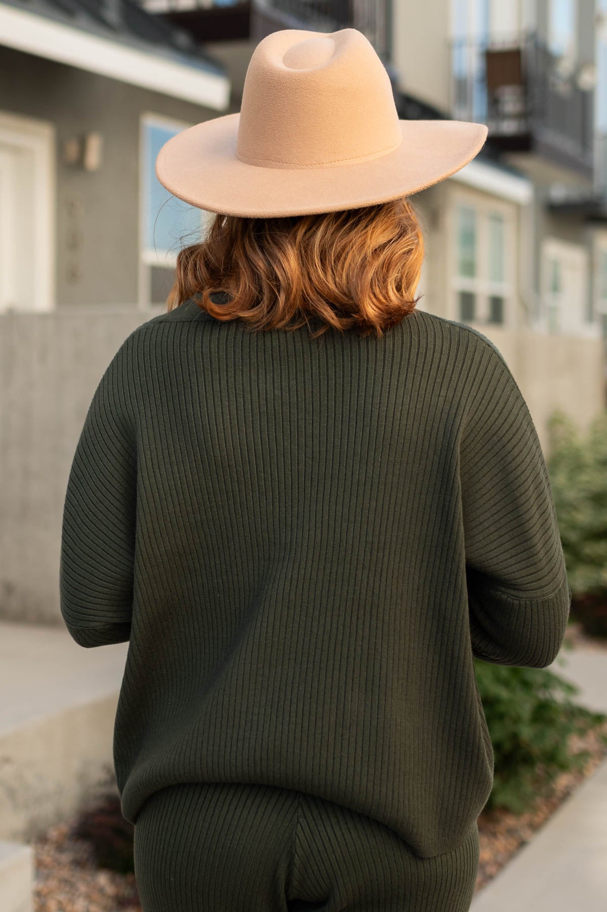 Back view of a dark green sweater