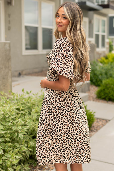 Side view of a taupe cheetah dress with short sleeves