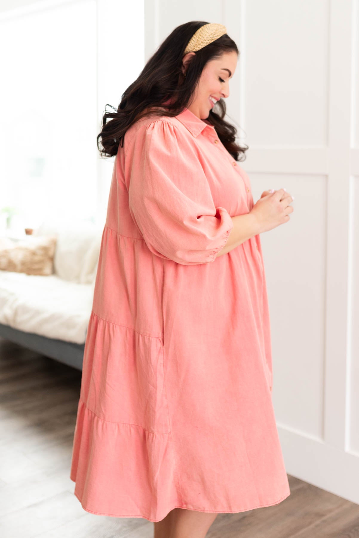 Side view of the plus size pink button down dress with pockets