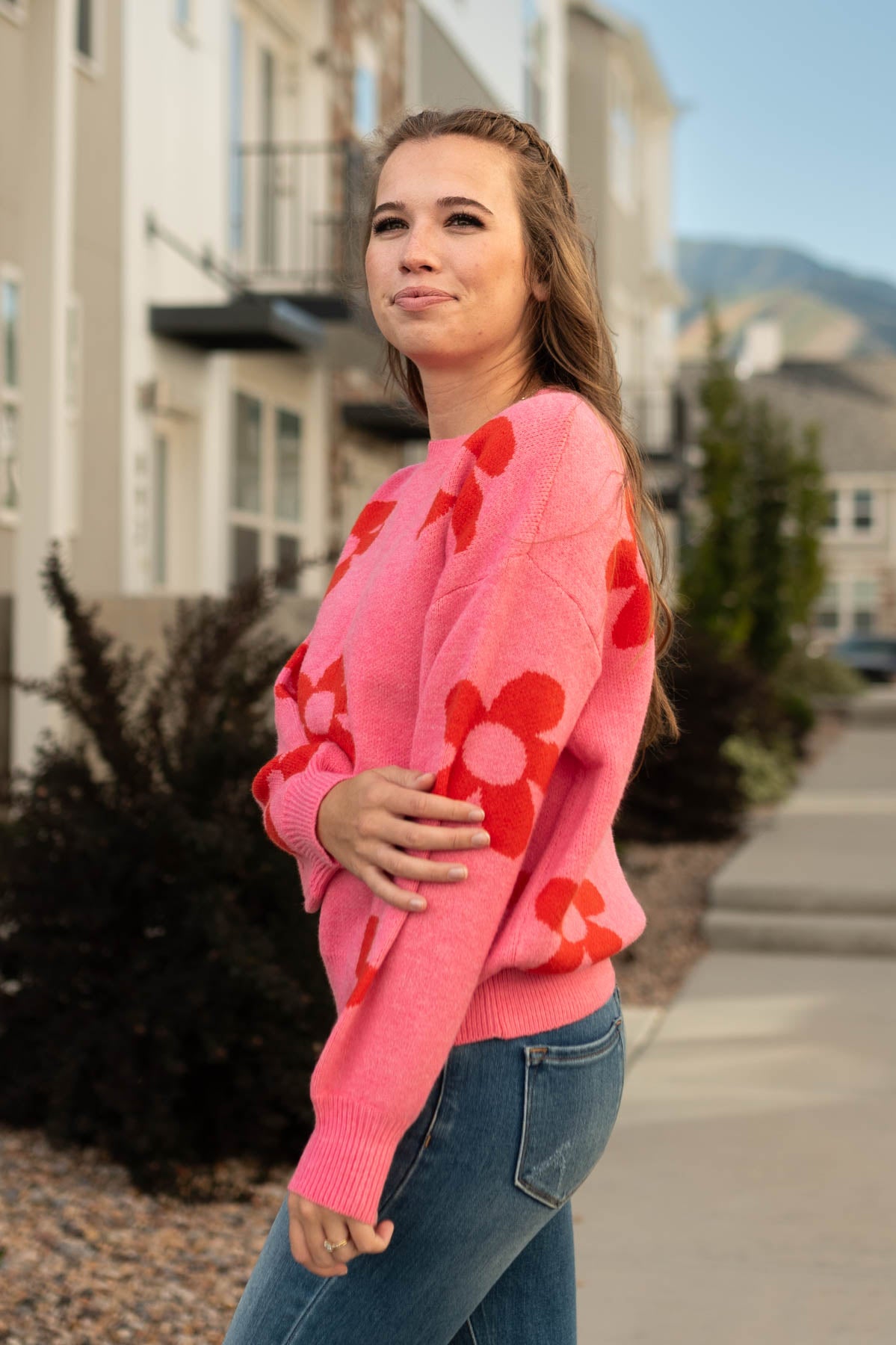 Side view of a pink floral sweater