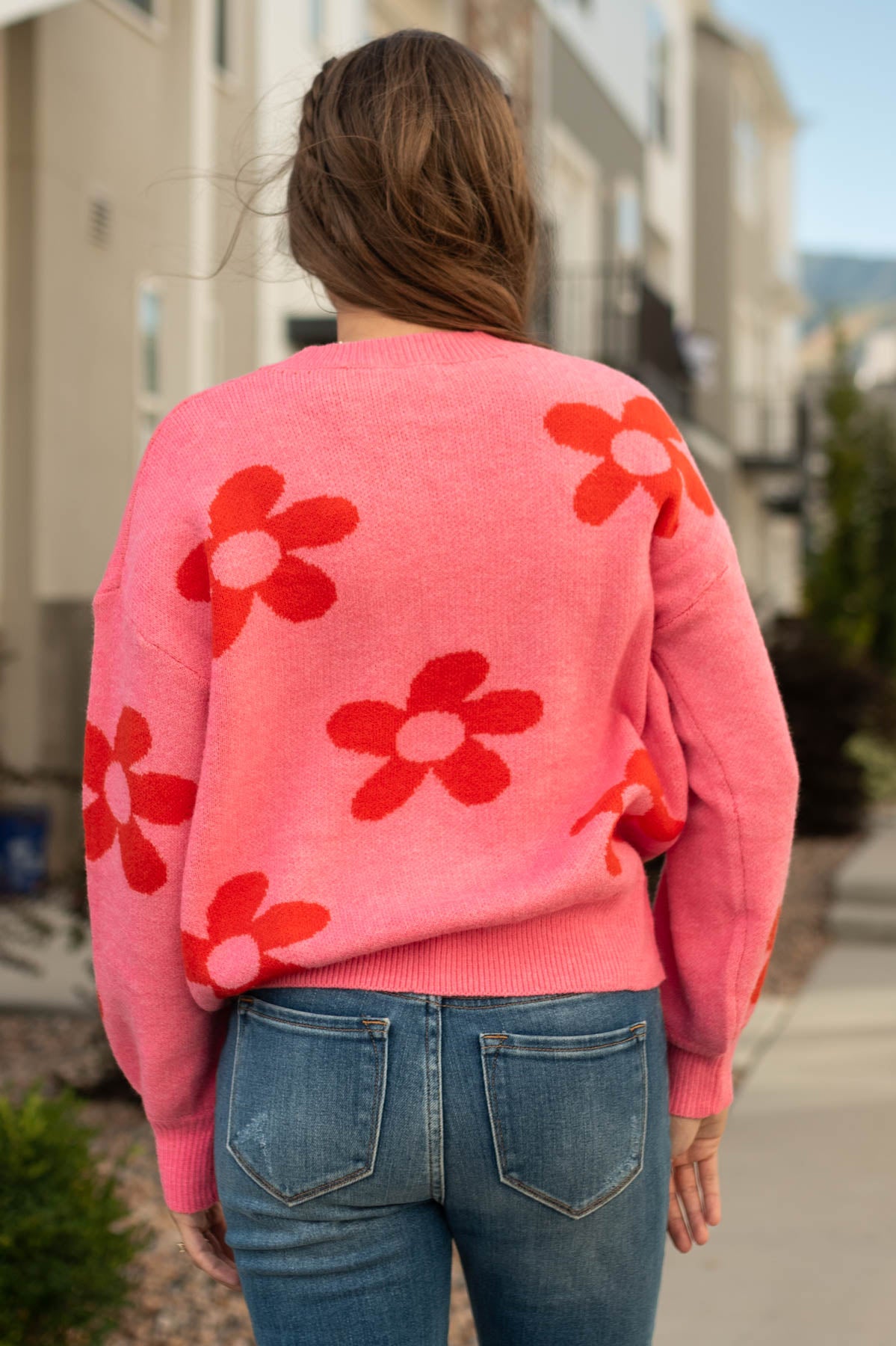 Back view of a pink floral sweater