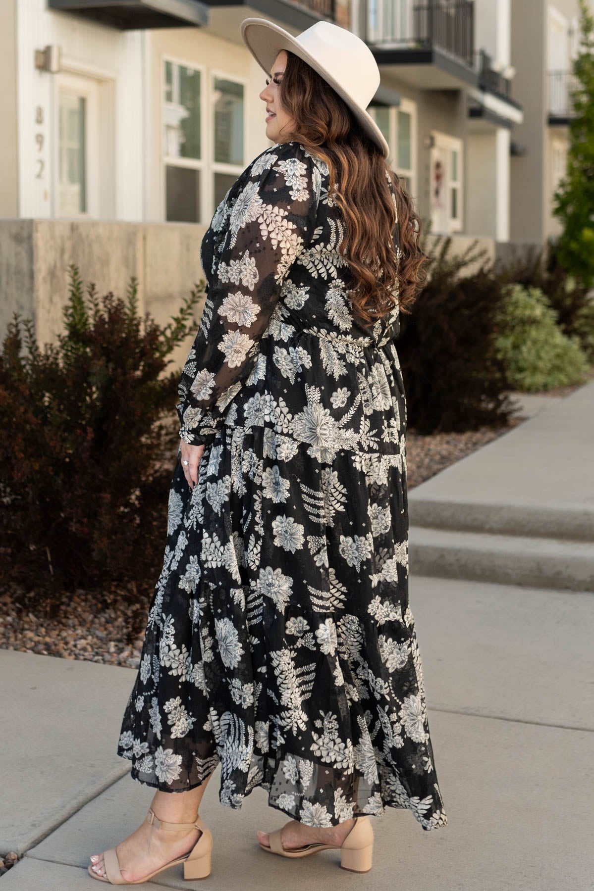 Side view of a plus size black dress with floral print