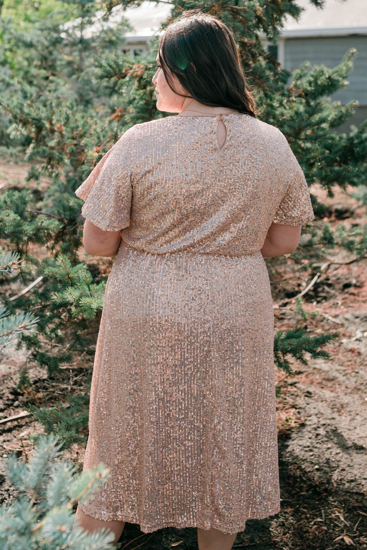 Back view of a plus size rose gold sequin dress