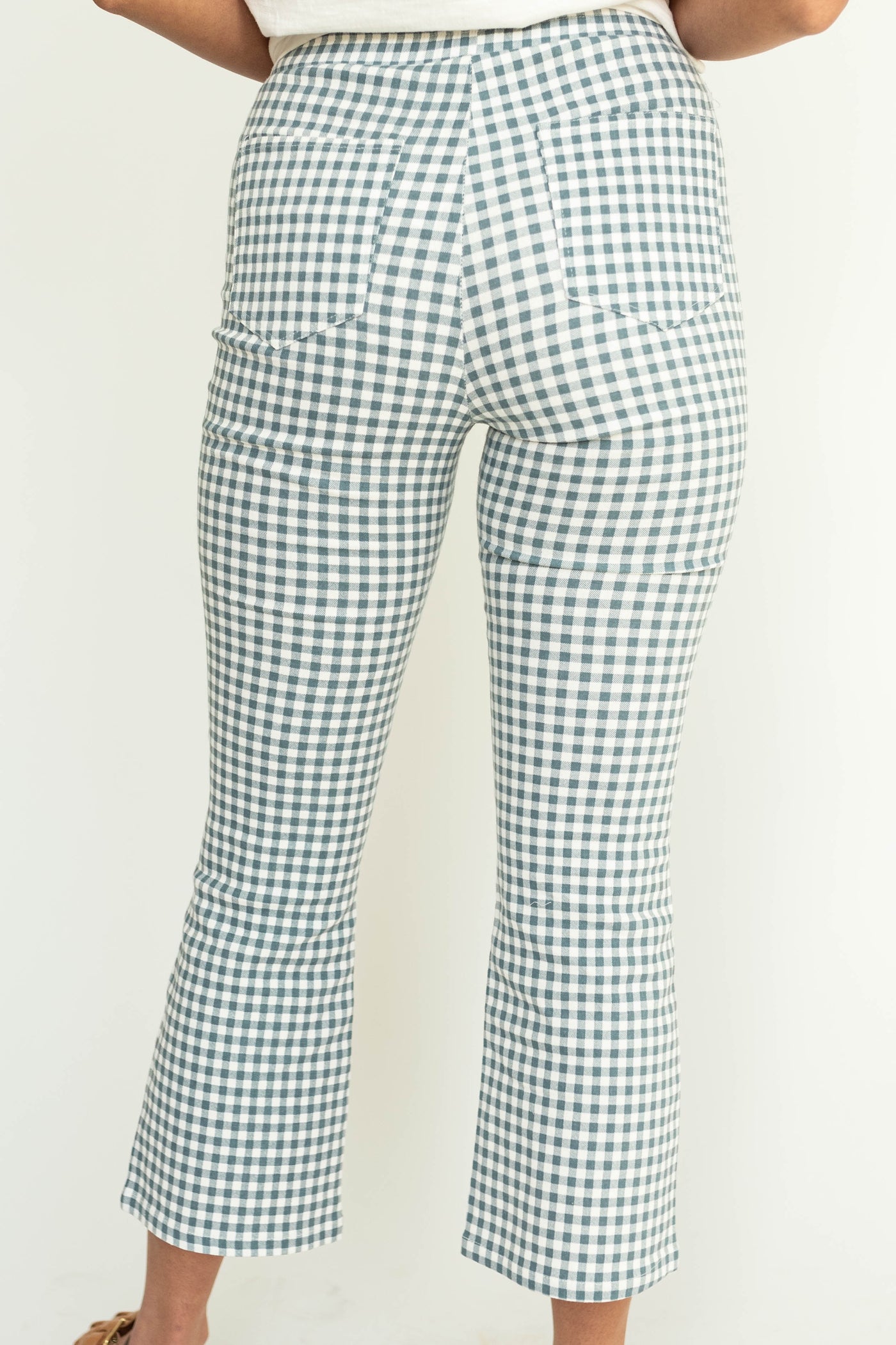 Back view of ankle length checkered seafoam straight leg pants.