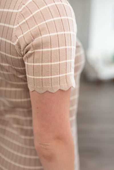 Close up of the sleeve and fabric of the taupe ribbed sweater dress