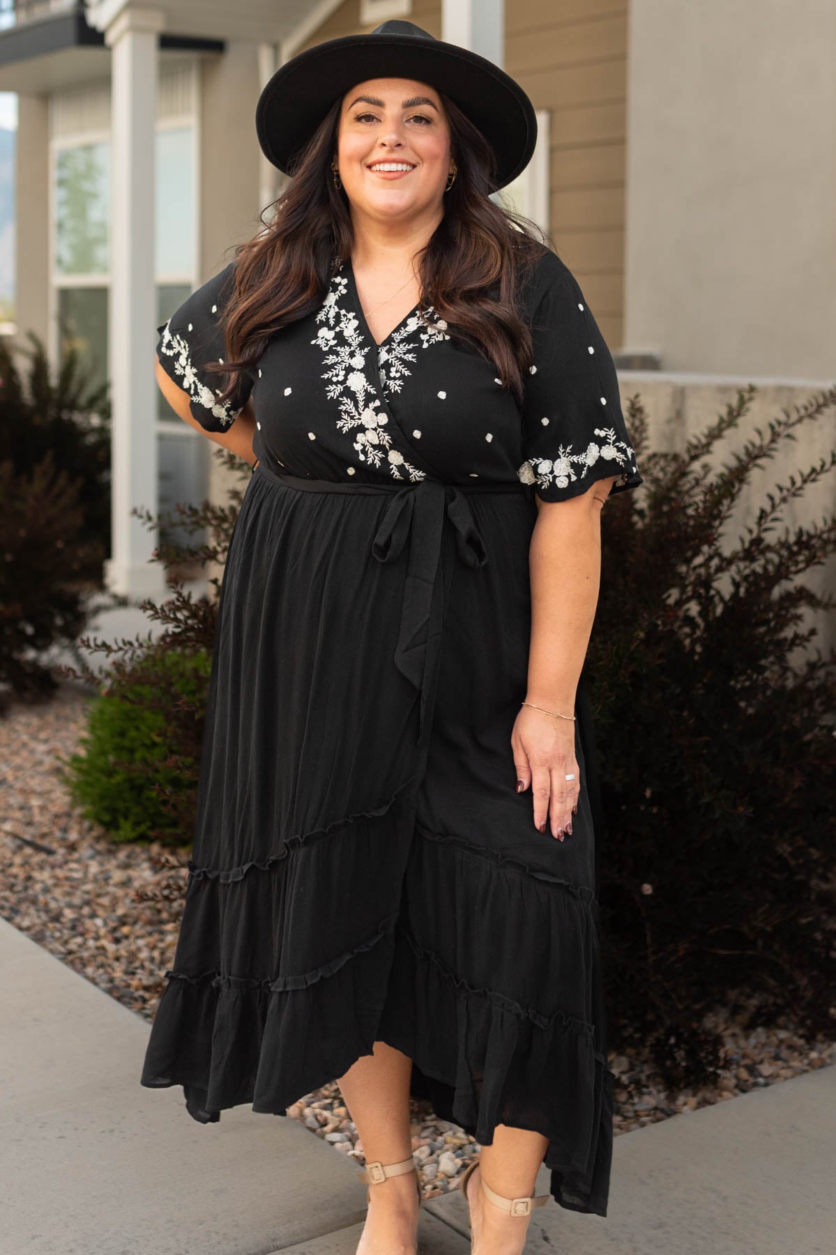 Plus size black floral dress that ties at the waist and has embroidery on the bodice