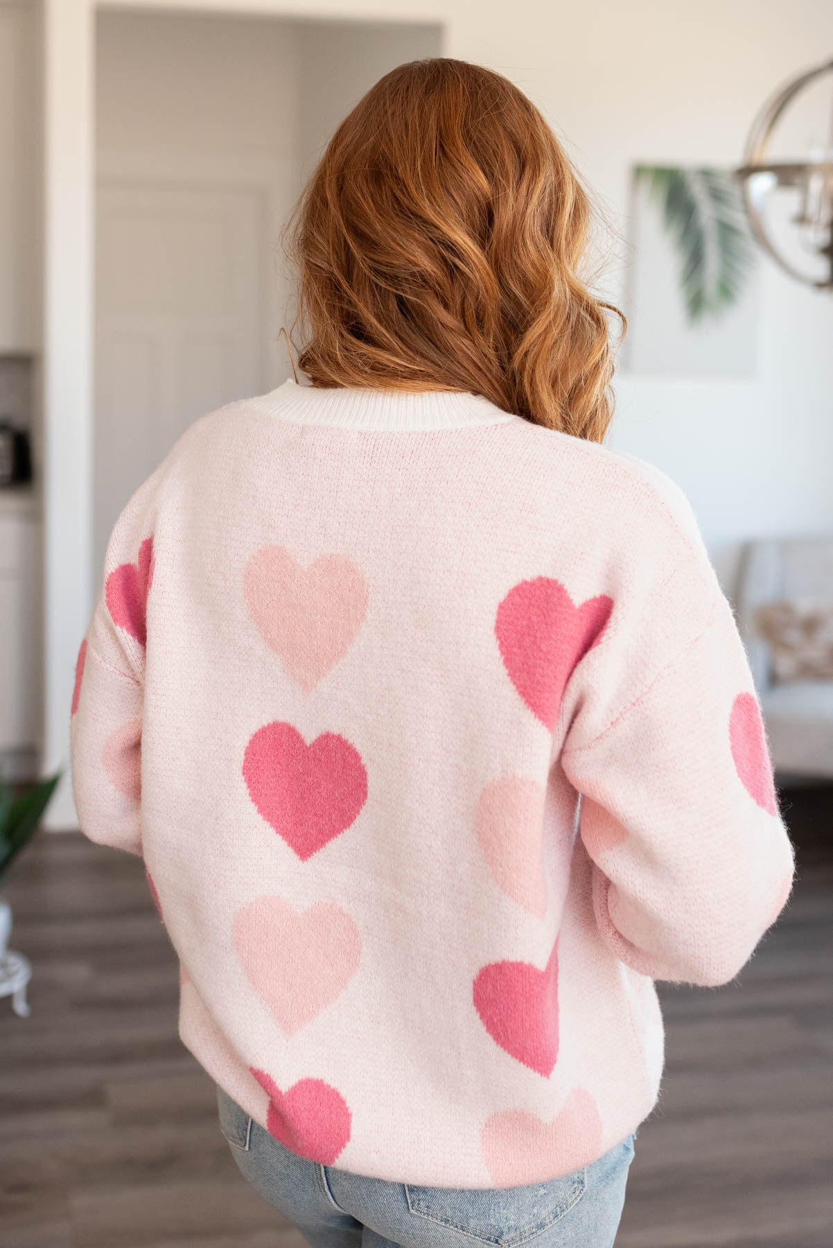 Back view of a pink heart sweater