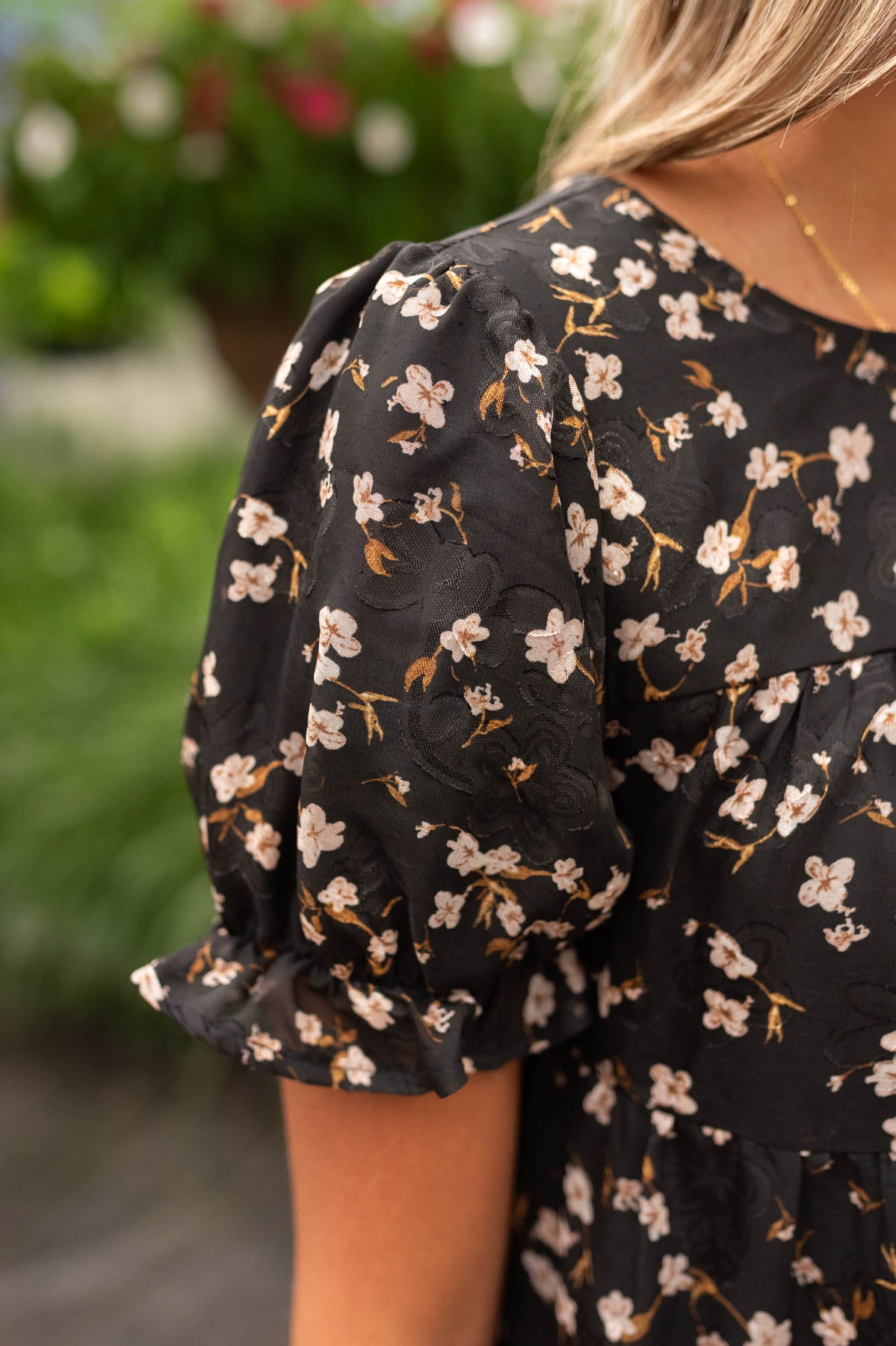 Close up of the floral pattern on the black floral midi dress
