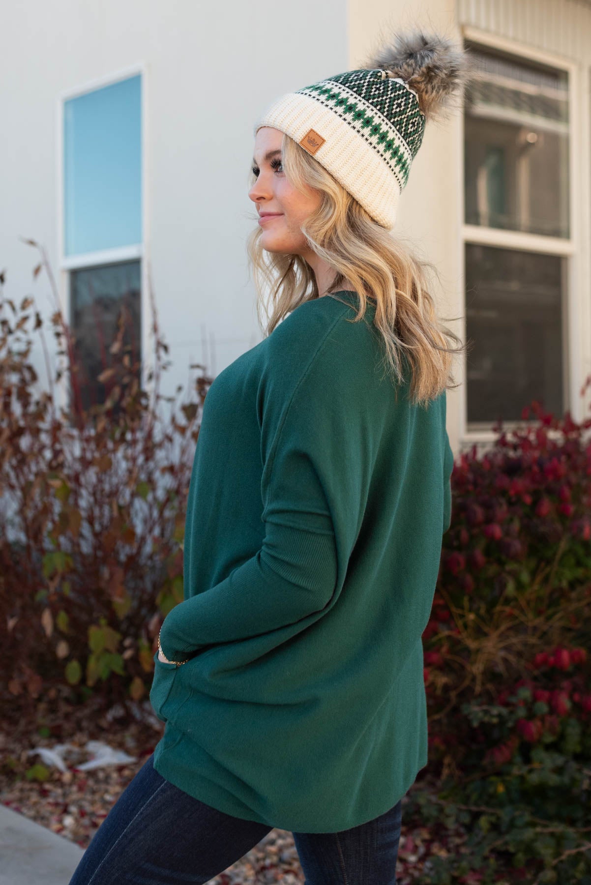 Side view of the hunter green pocket sweater