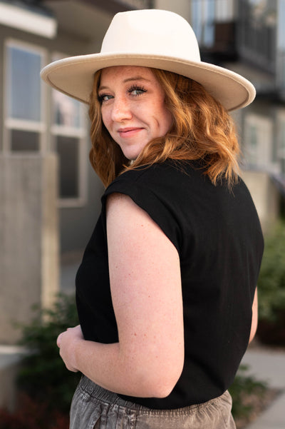 Side view of a black top with cap sleeves