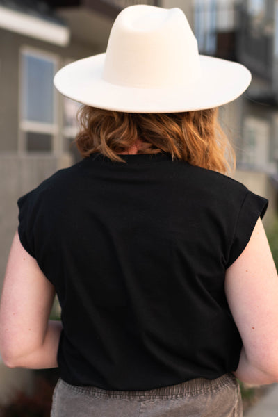 Back view of a black top with cap sleeves