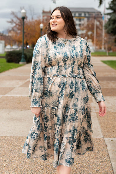 Long sleeve plus size beige floral dress with teal flowers and tiered skirt