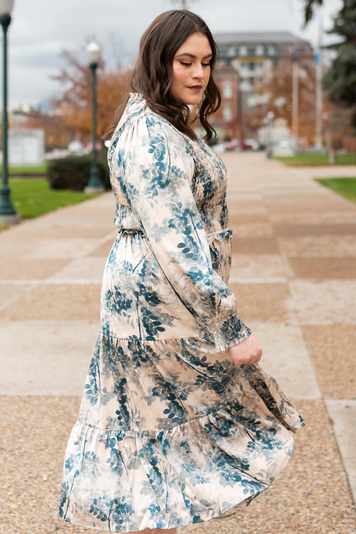 Side view of a plus size beige floral dress