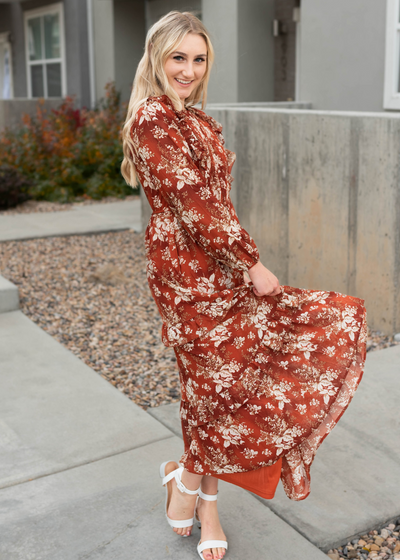 Rust floral maxi dress with long sleeves and ruffle hem