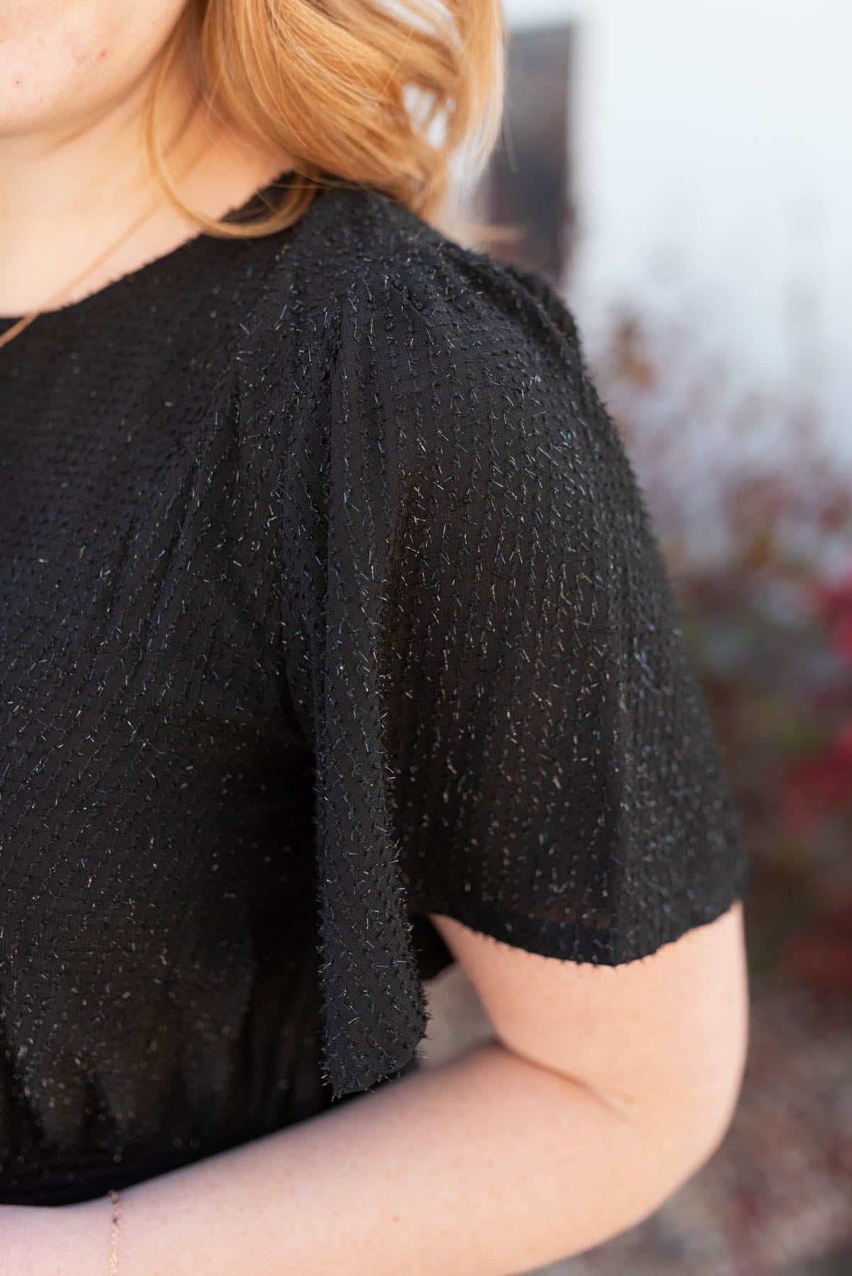 Close up of the fabric on a black sparkle maxi wrap dress