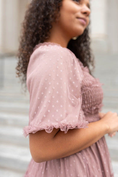 Close up of the sleeve of a dusty rose dress
