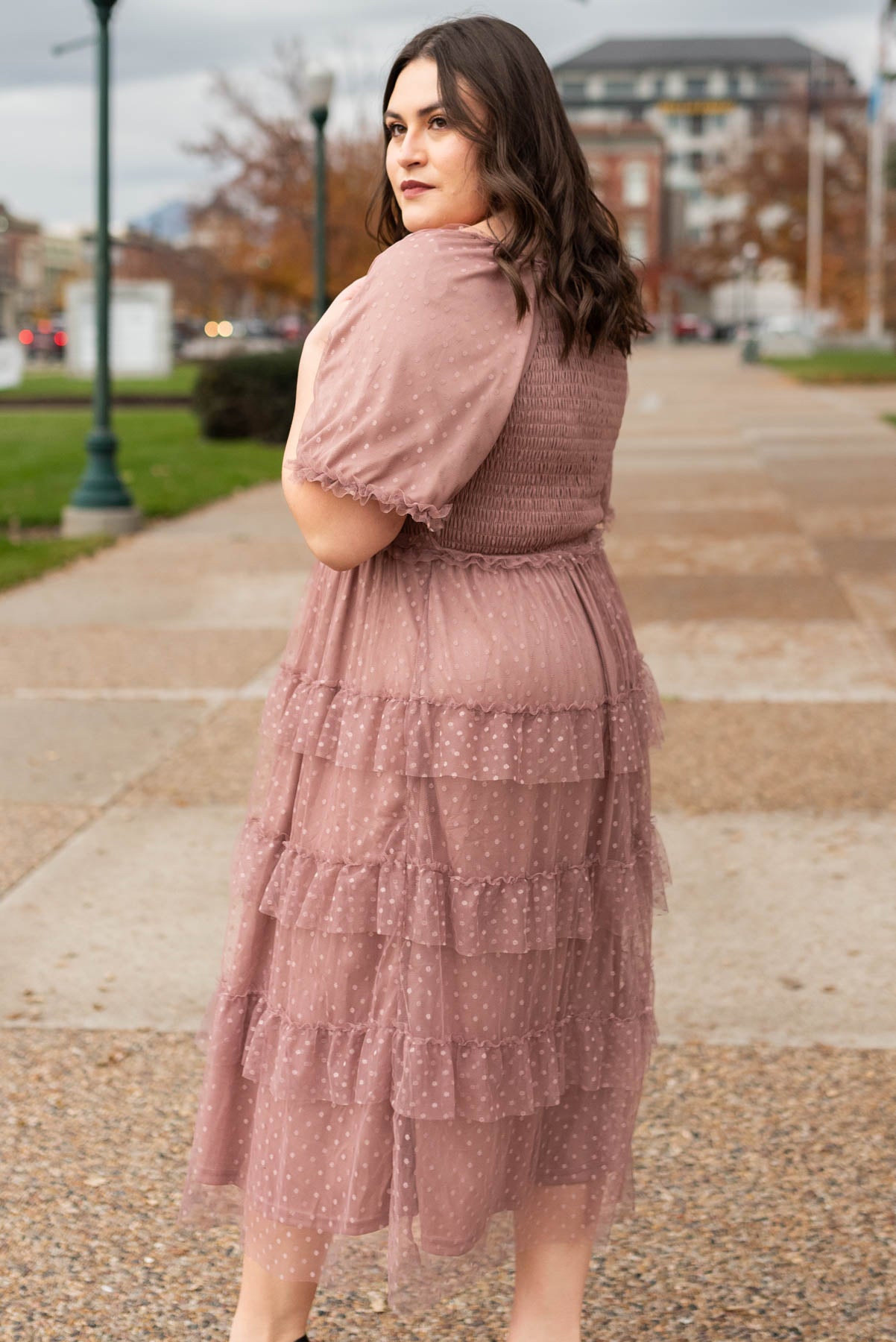Side view of the plus size dusty rose dress with dot on the tulle.