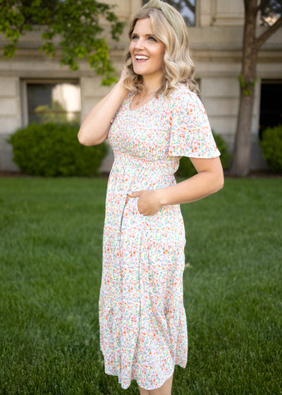 Coral floral dress with smocked bodice and short sleeves