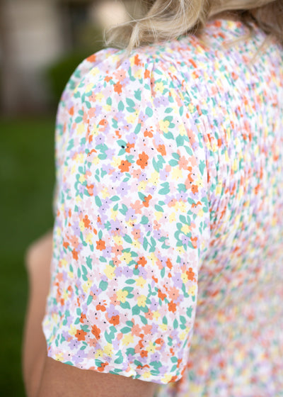 Sleeve of a coral floral dress
