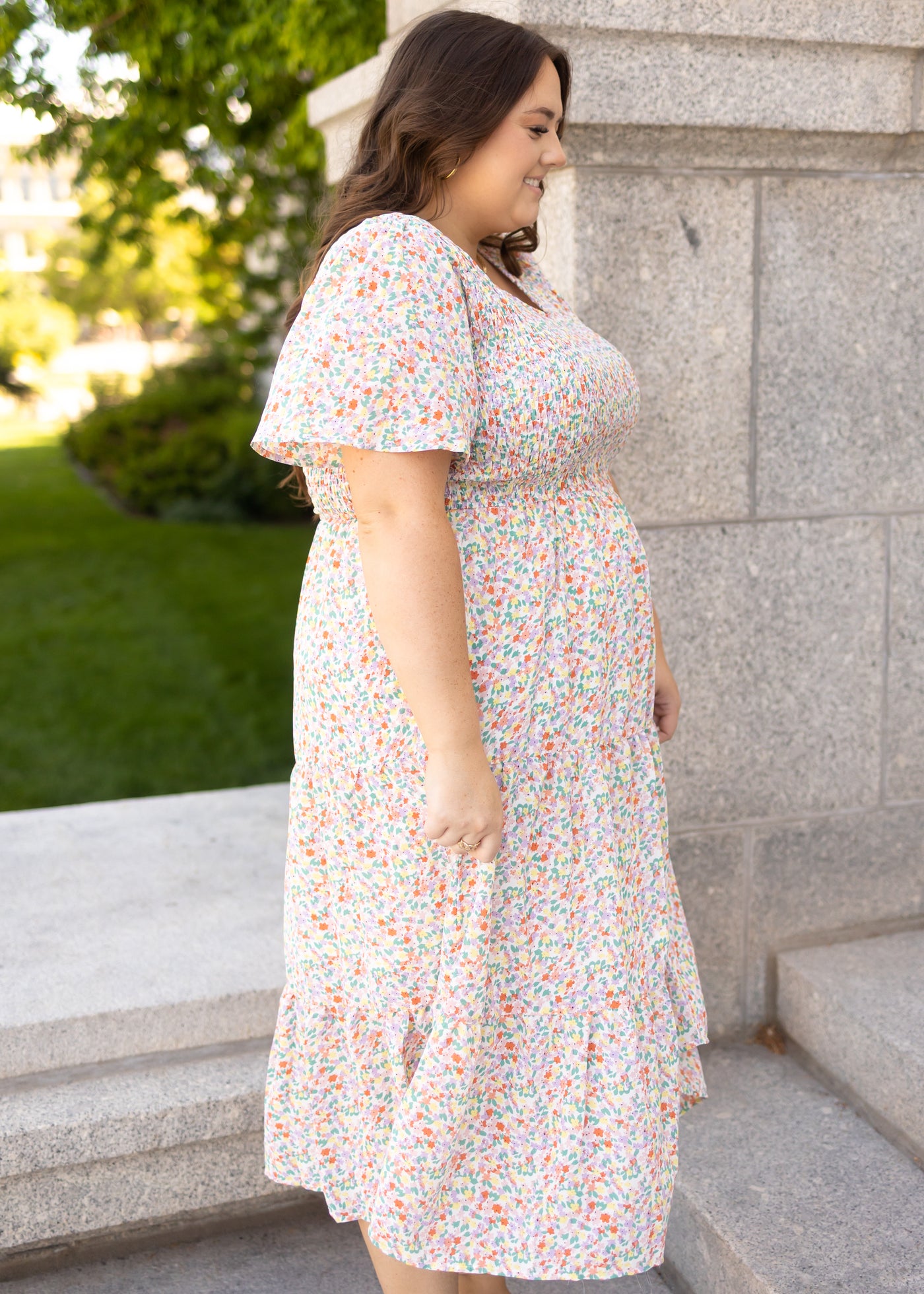 Side view of a short sleeve plus size coral floral dress