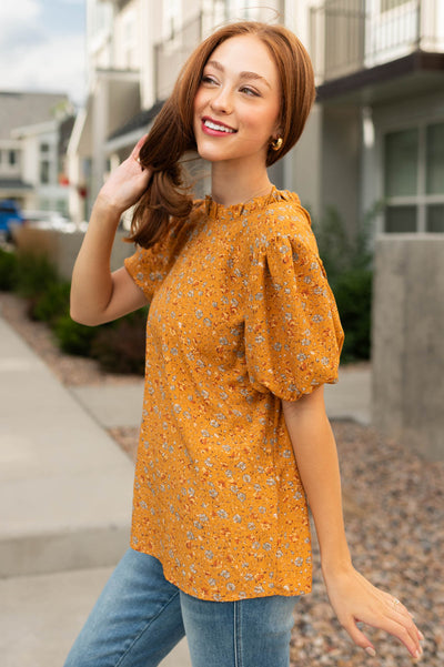 Side view of a short sleeve mustard top