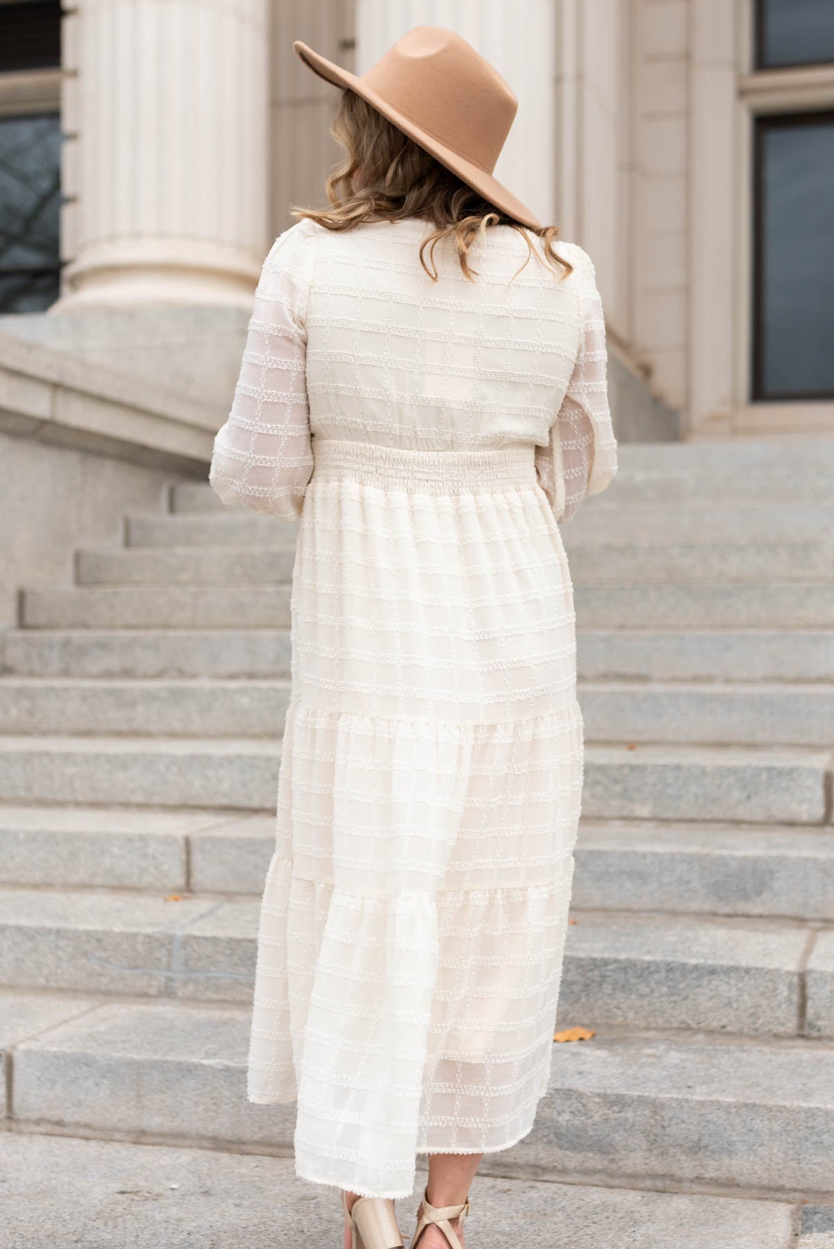 Back view of a cream glitter maxi dress