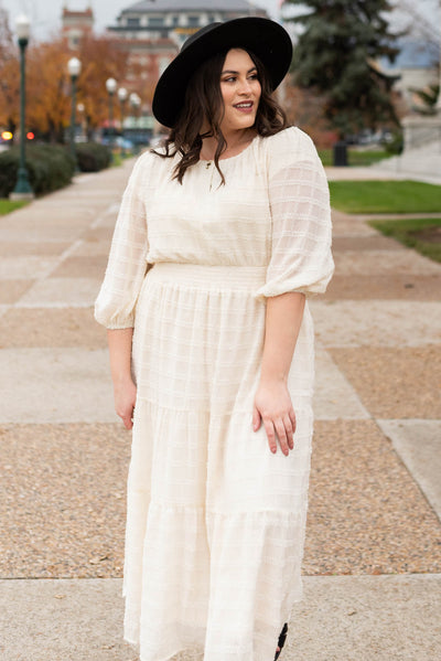 Front view of a plus size cream glitter maxi dress