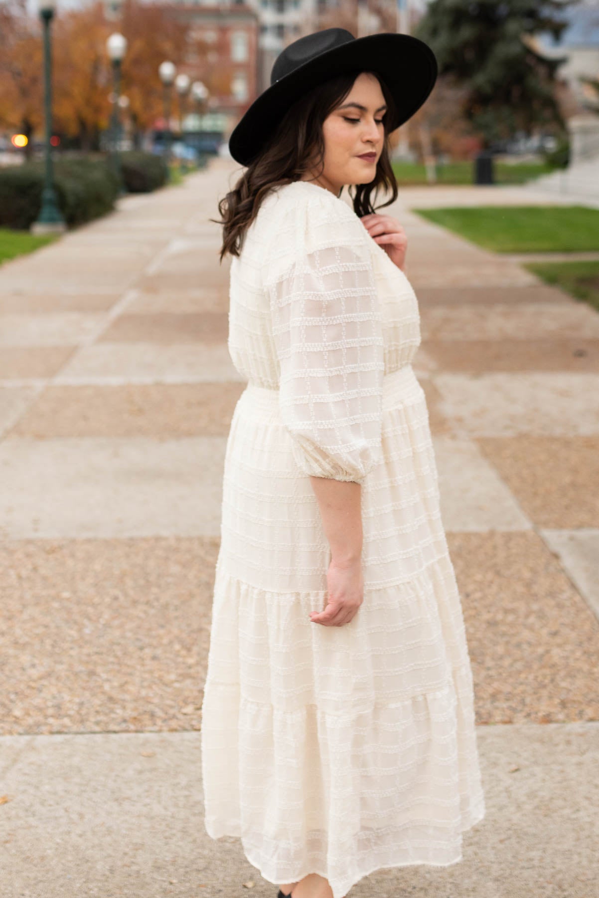 Side view of the plus size cream glitter maxi dress