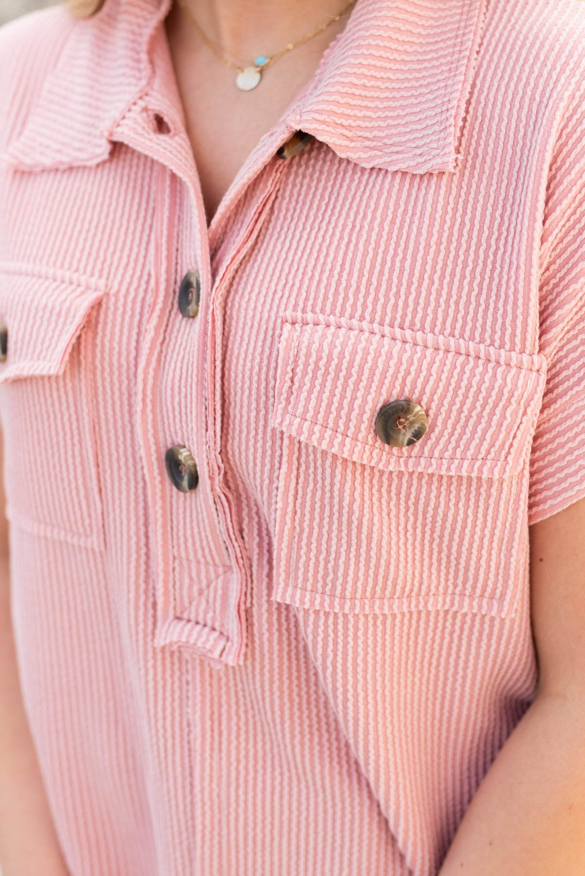 Close up of the buttons on the mauve button down top
