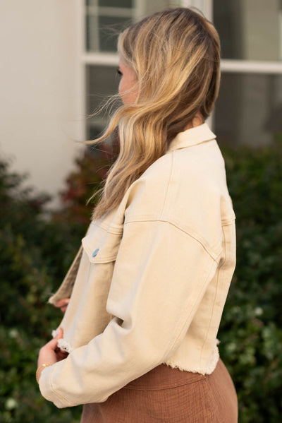 Side view of a beige button down jacket