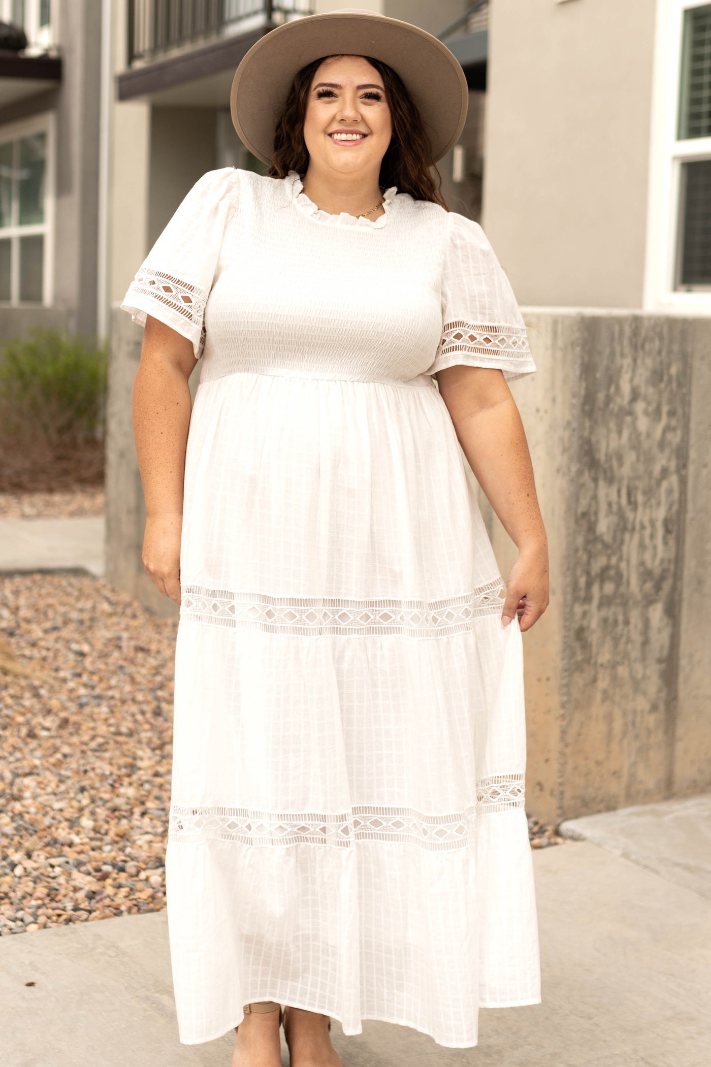 Front view of a long white dress with lace detail