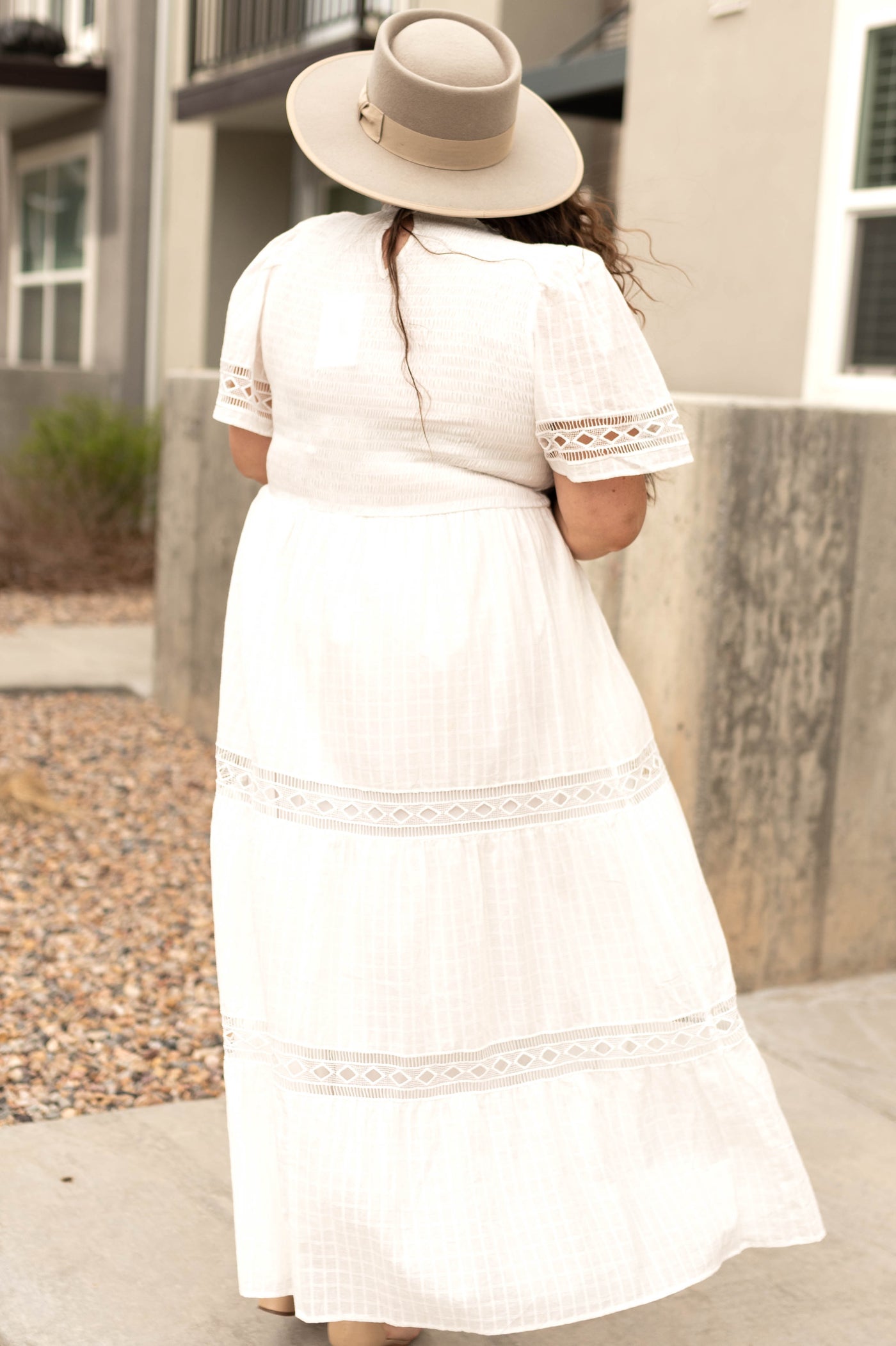 Back view of a plus size long white dress with lace detail