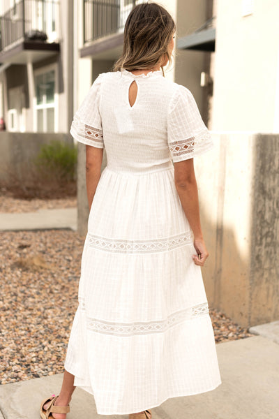 Back view of a white dress with lace detail