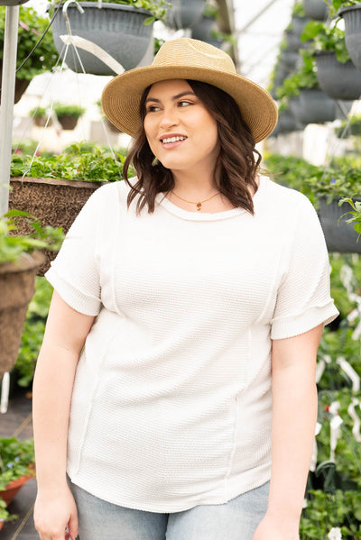 Size 1X of the white ribbed knit top