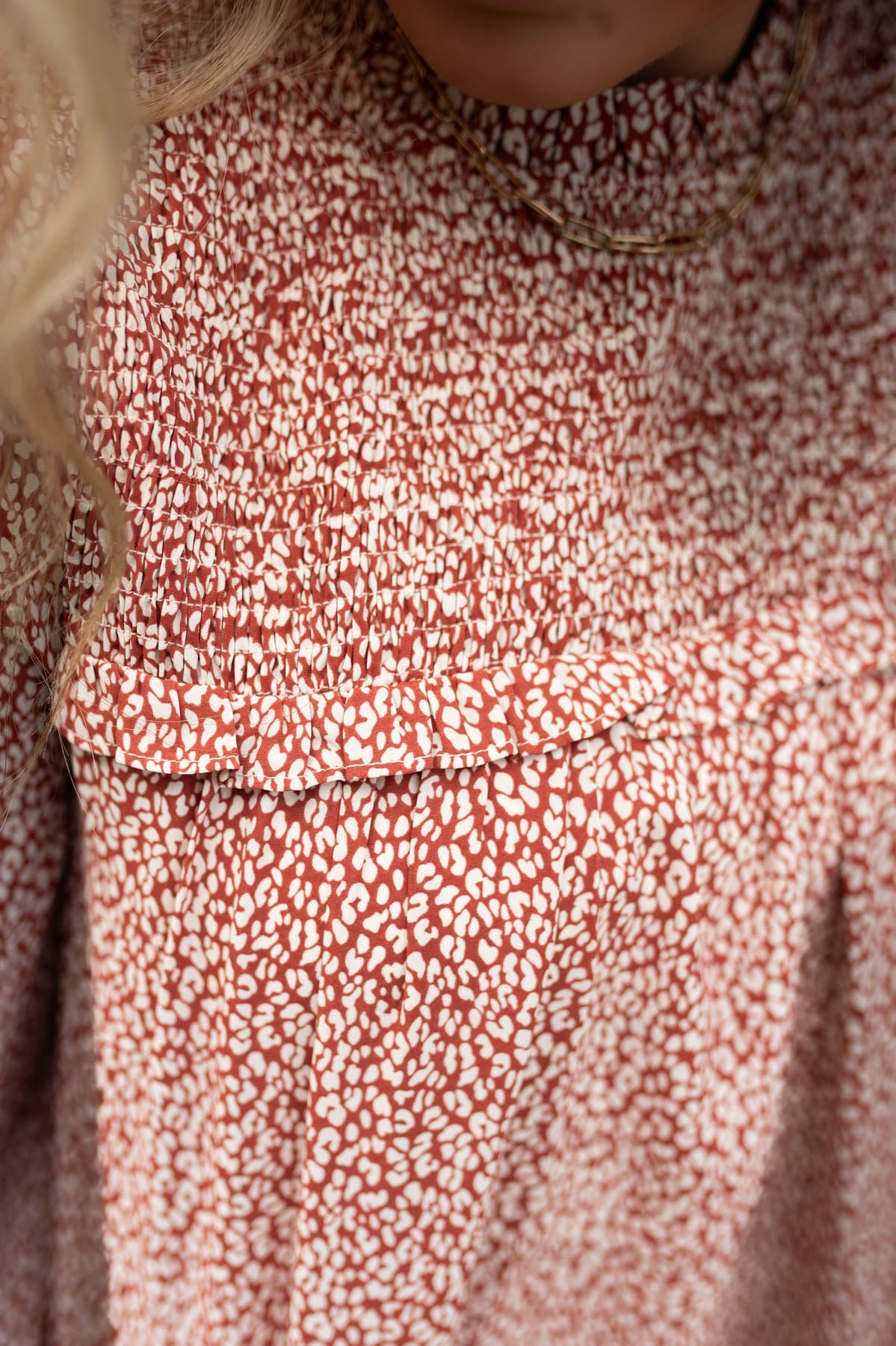 Close up of the smocking on a brick cream top