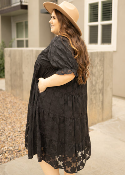 Side view of a plus size black dress with pockets