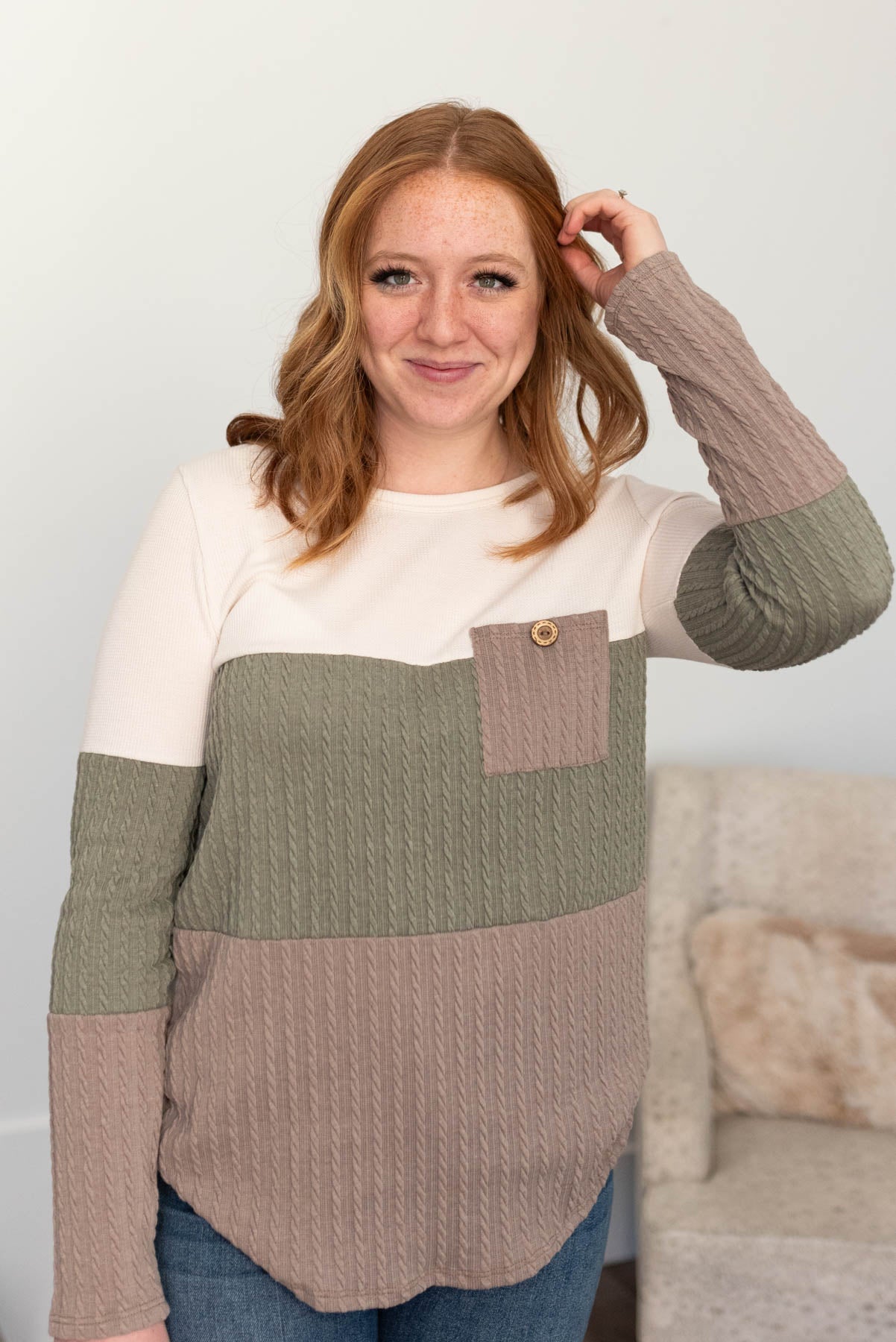 Olive pocketed cable knit top with cream and tan color blocks