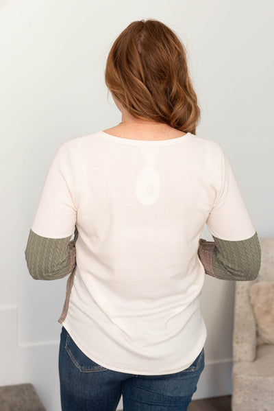 Back view of the olive pocketed cable knit top