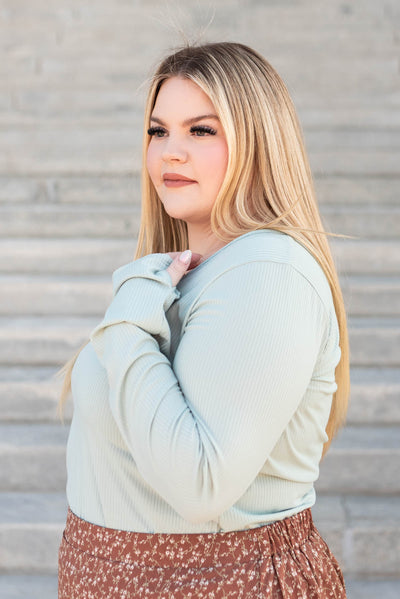 Side view of the plus size sage ribbed long sleeve top
