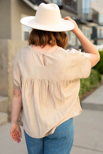 Back view of a medium beige top