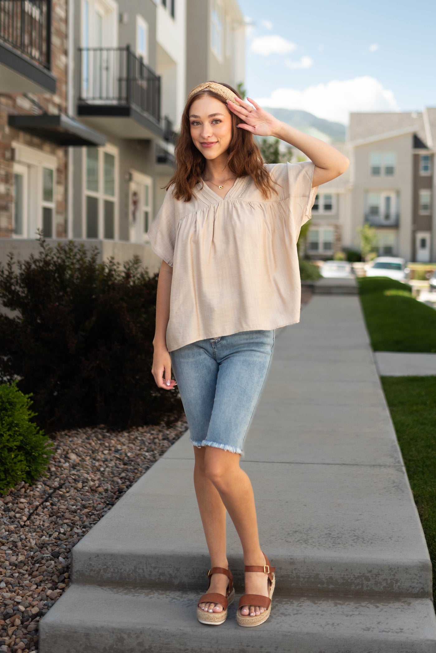 Side view of a short sleeve beige top