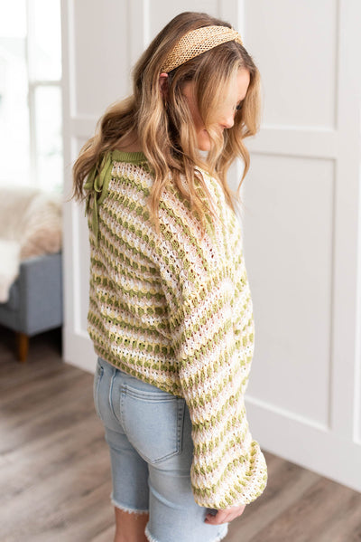 Side view of the lime knit pullover