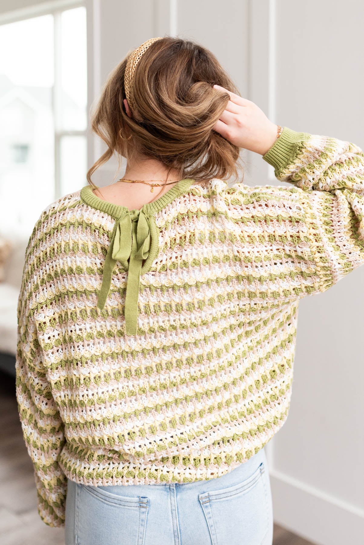 Back view of the lime knit pullover with a tie back
