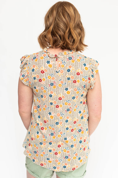 Back view of a taupe floral top