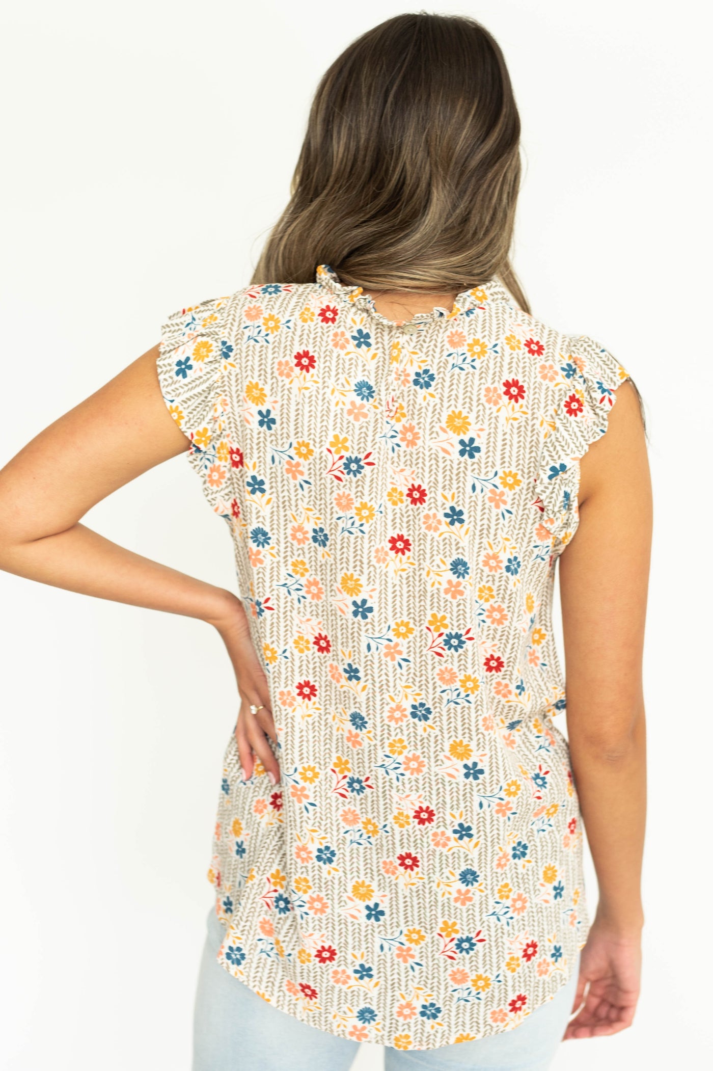 Back view of taupe floral top.