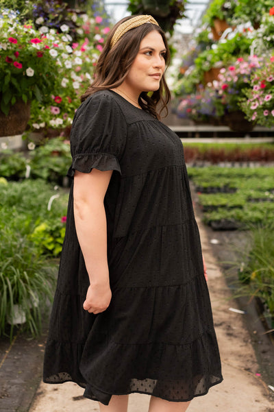 Side view of the plus size black dot midi dress