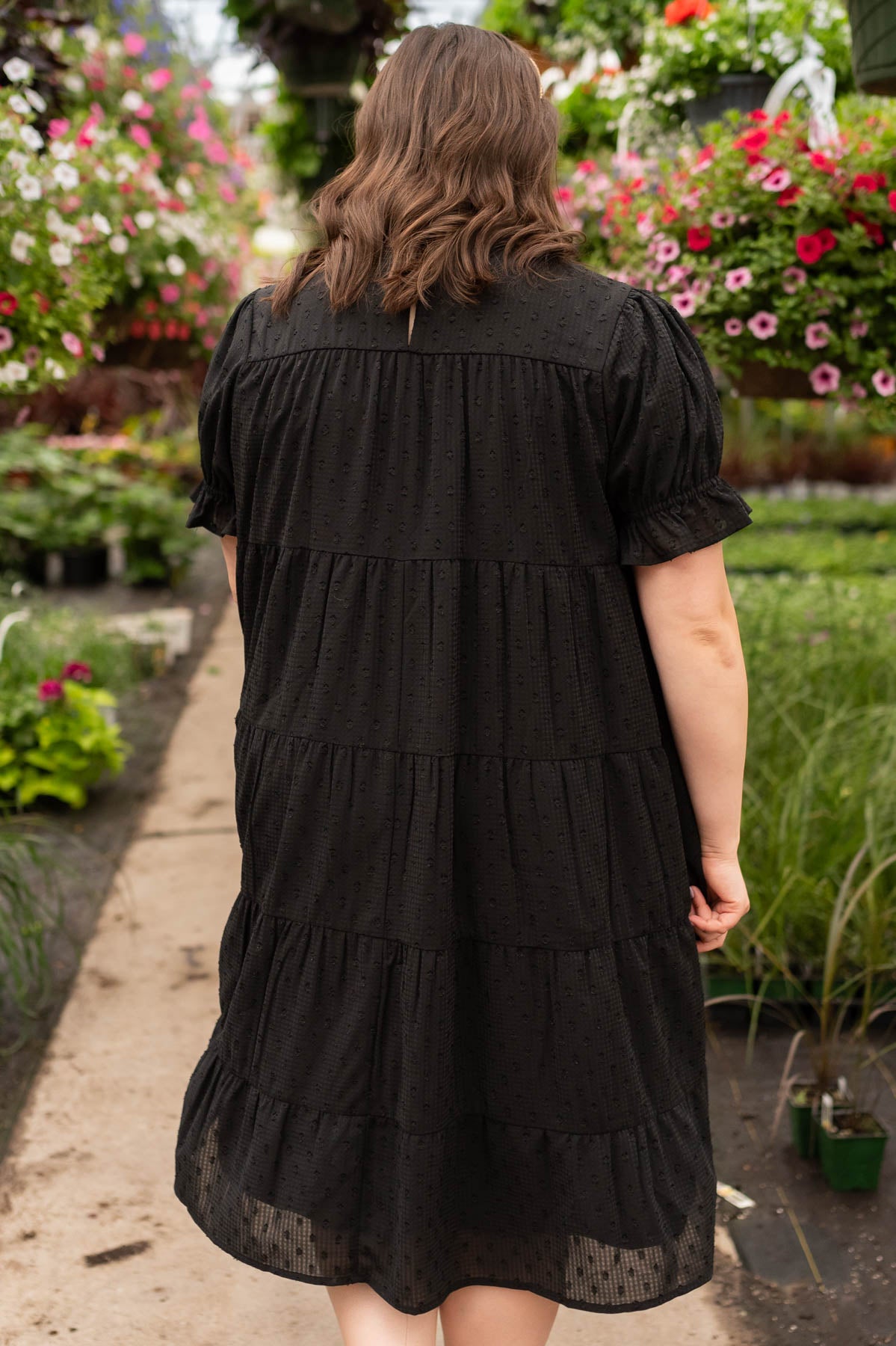 Back view of the plus size black dot mid dress