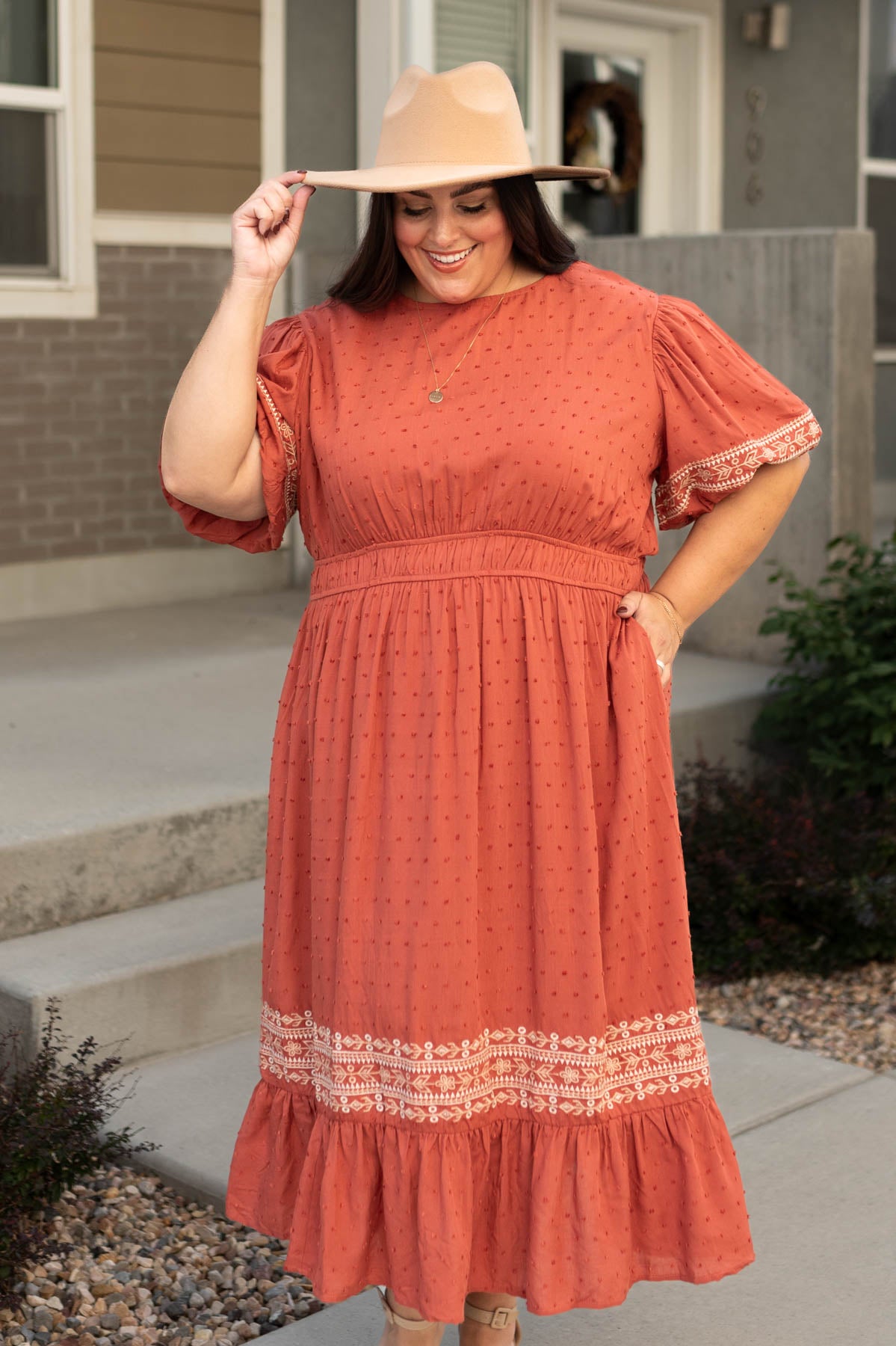 Plus size rust dress with embroidery on the sleeves and hem