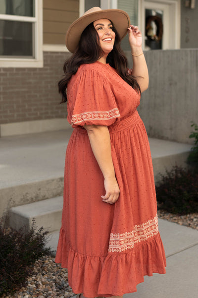 Side view of a plus size rust dress