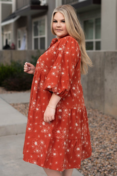 Side view of a plus size rust corduroy embroidered dress